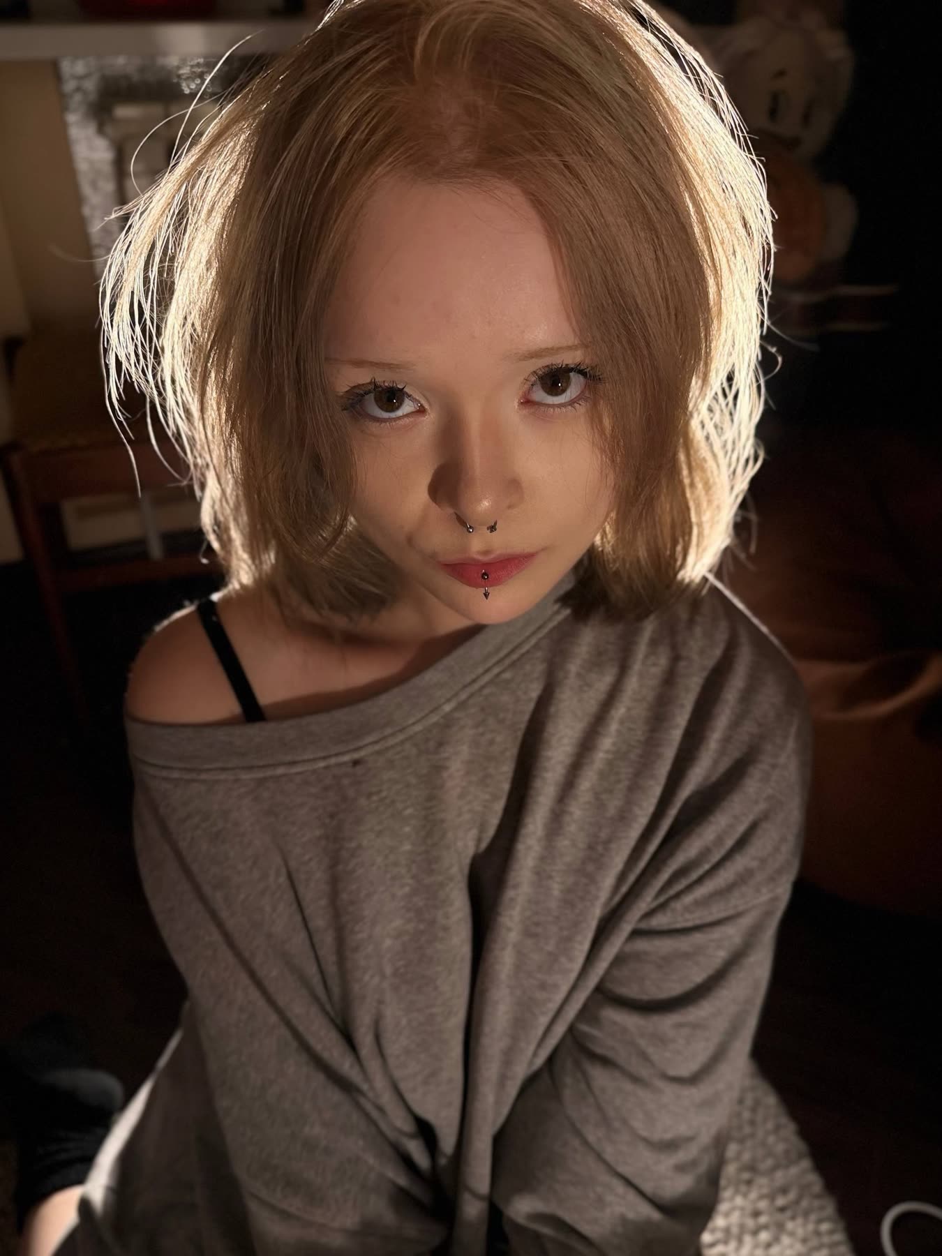 Milana looking straight up into the camera, warm backlight in her hair
